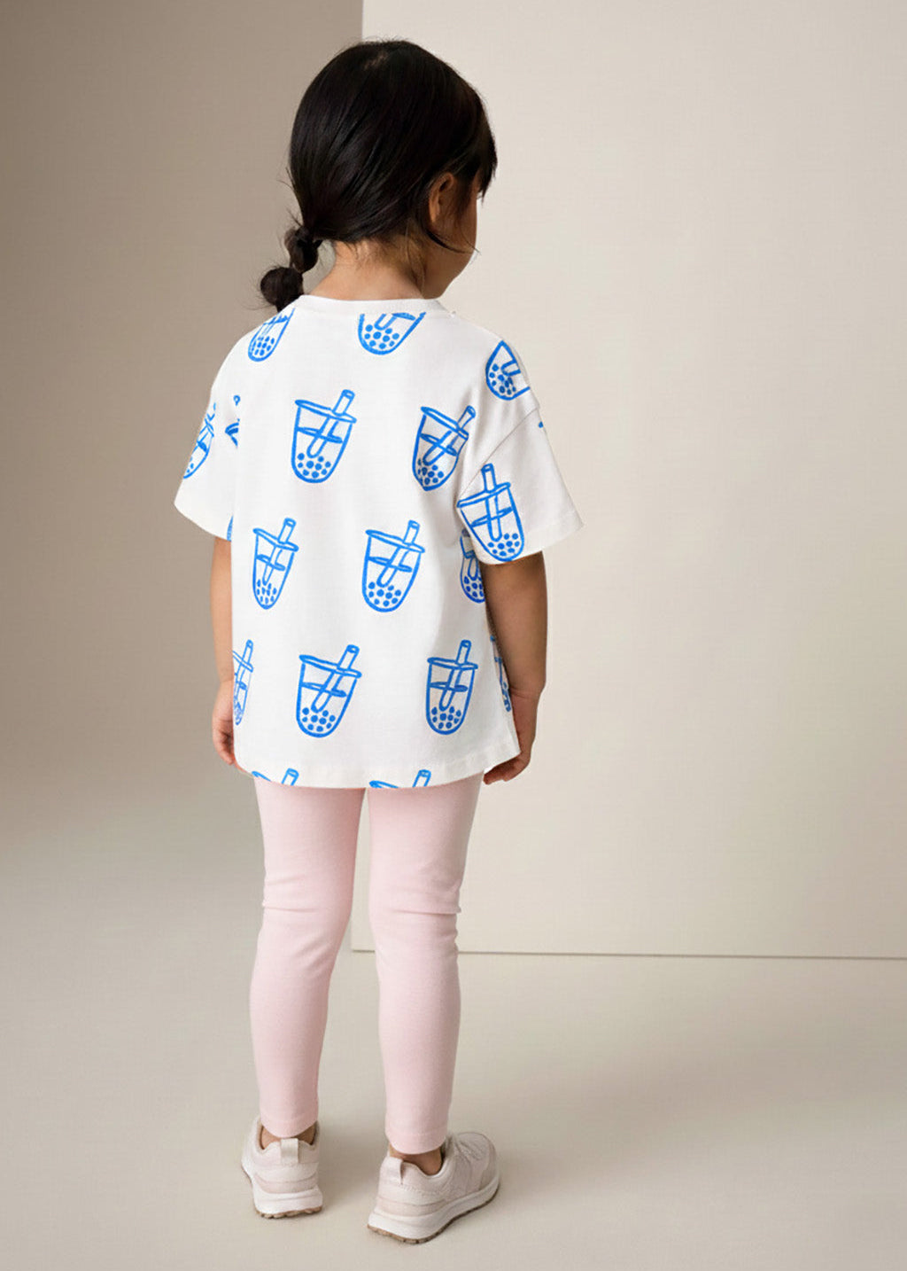 Girl wearing white kids t-shirt with blue boba bubble tea graphic print