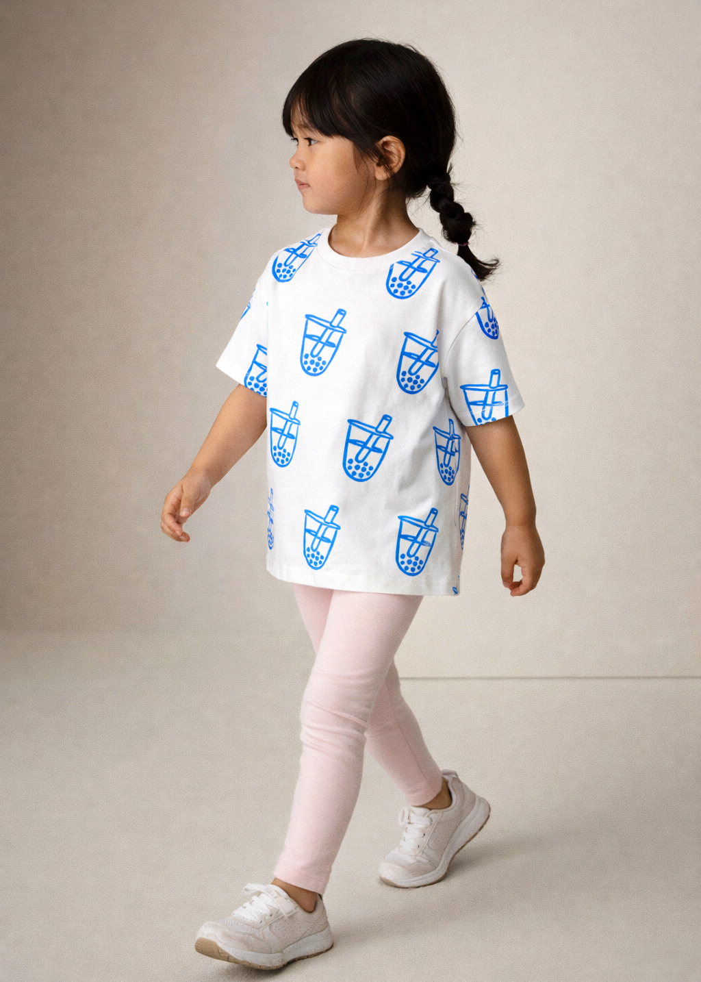Girl wearing white kids t-shirt with blue boba bubble tea graphic print